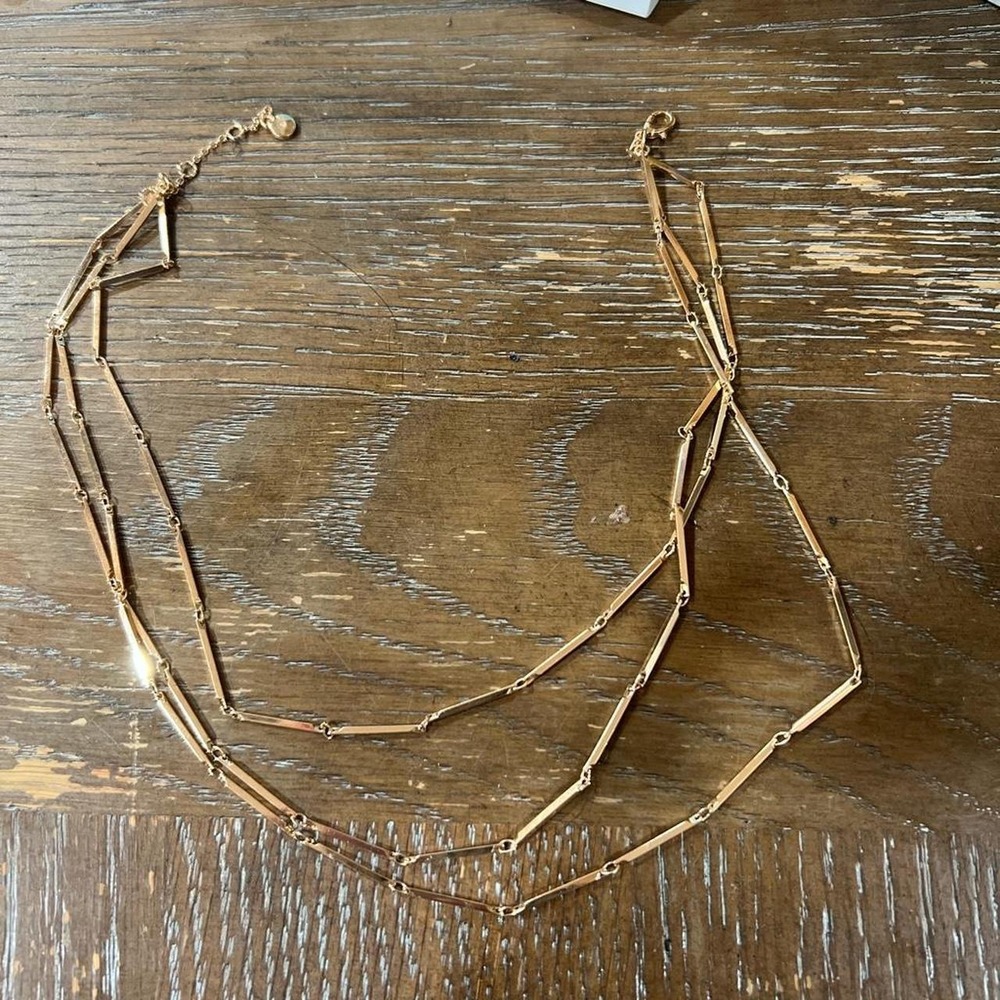 Gold tone layered necklace with a touch of vintage charm'
